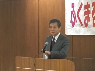 演台に設置されたマイクに向かって話をしている成山治彦先生の写真